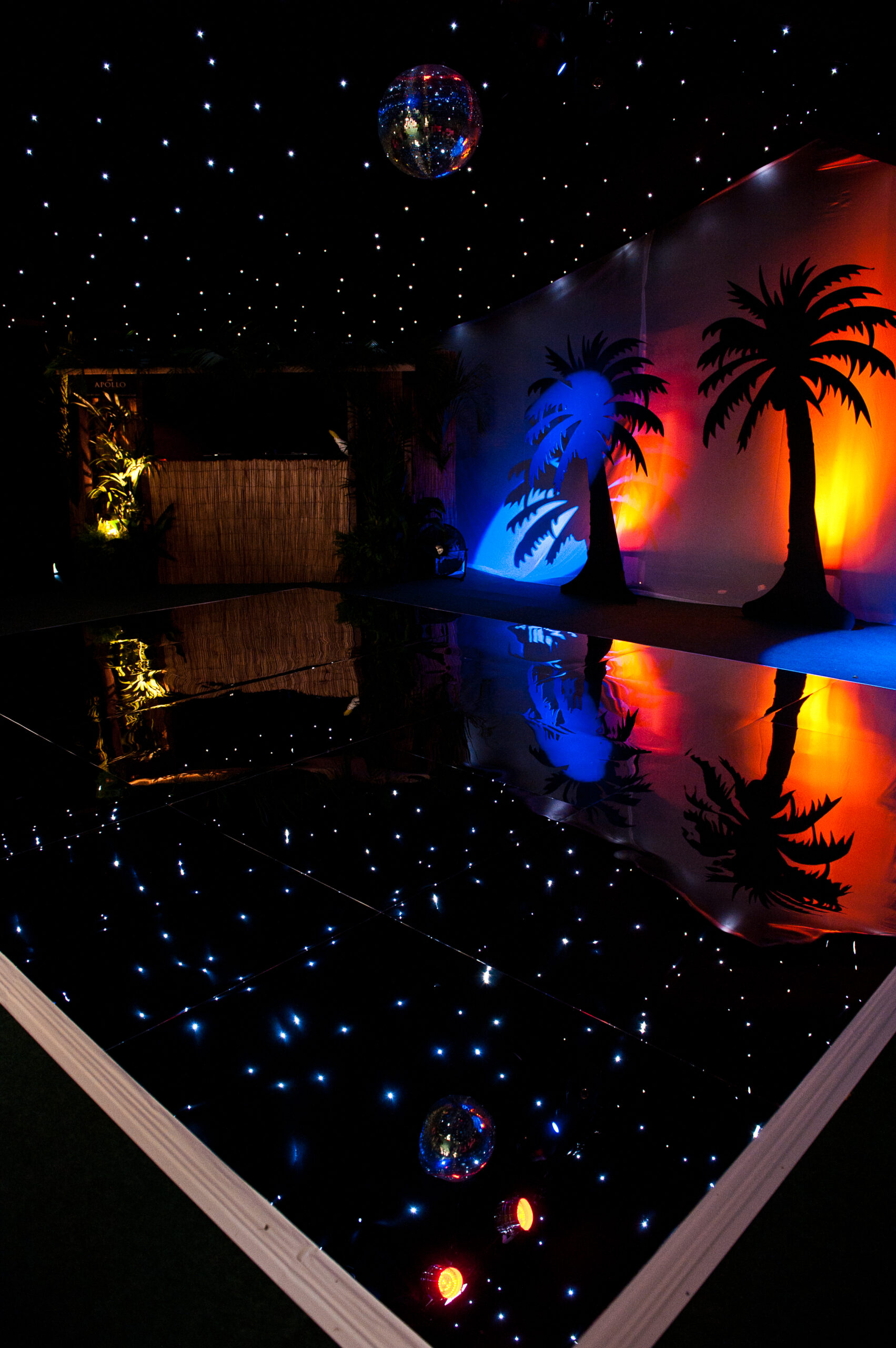LED pea light dance floor - Beech party theme LED dance floor with starcloth ceiling, mirror ball and colourful party lighting.