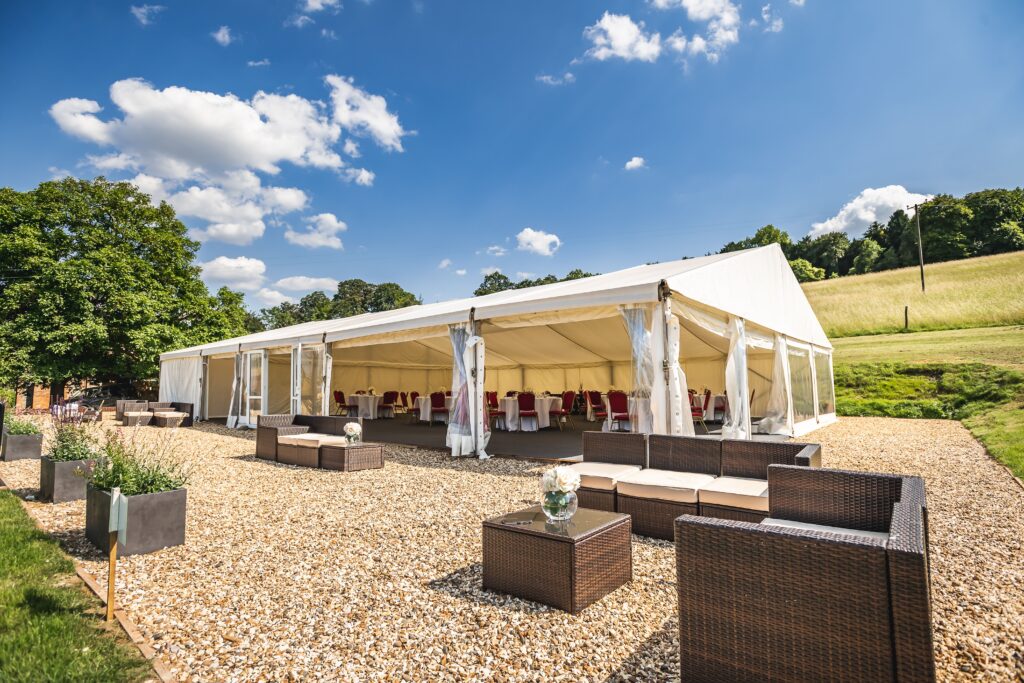 Elegant clearspan marquee set on a countryside gravel terrace with outdoor seating in Surrey